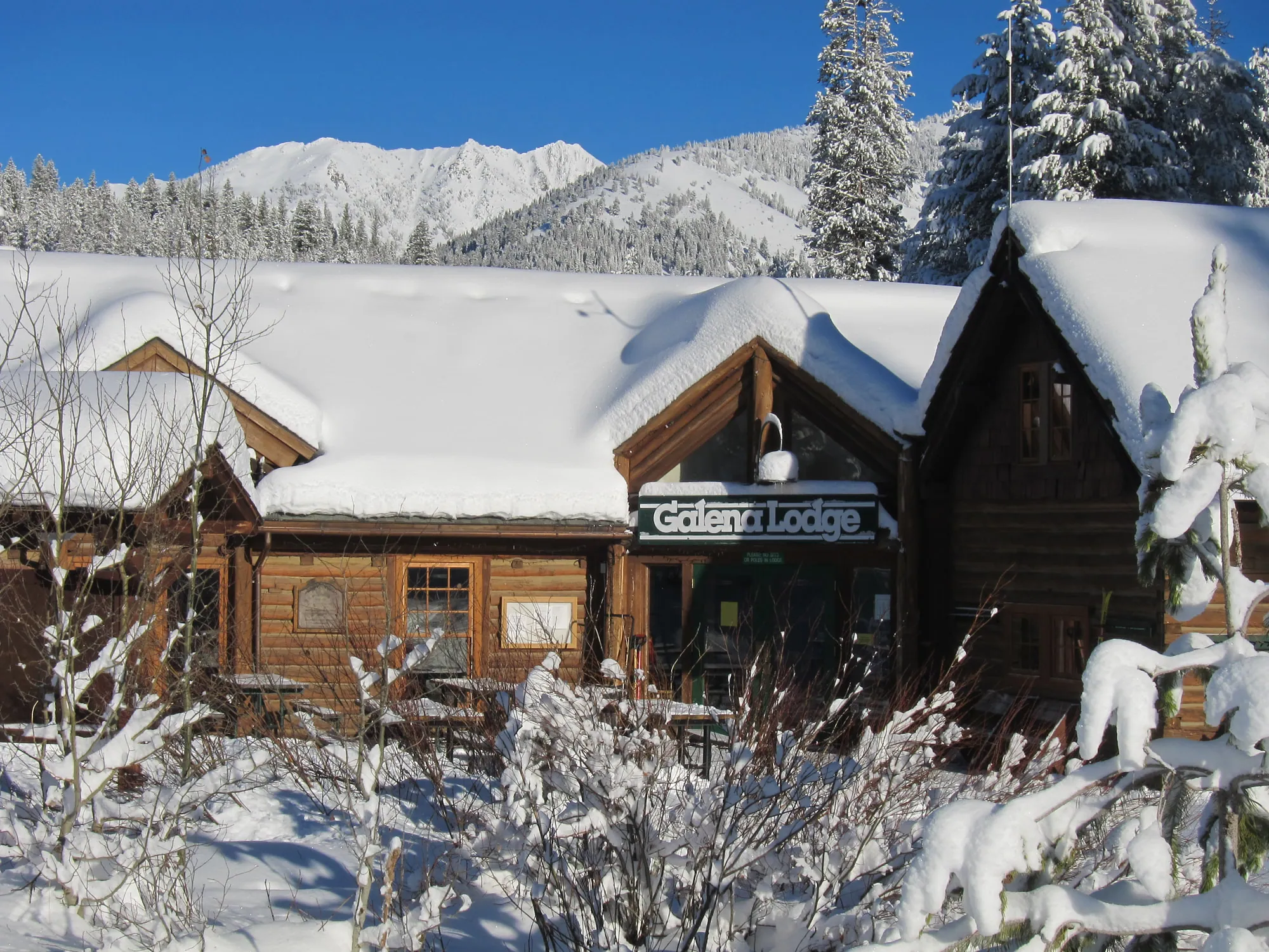 Galena Lodge in winter, roofs deep in snow under the Boulder Mountains