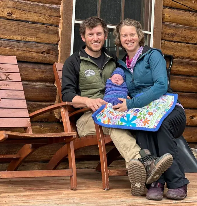 Kyle and Chelan Oldemeyer with baby Sage on the lodge porch